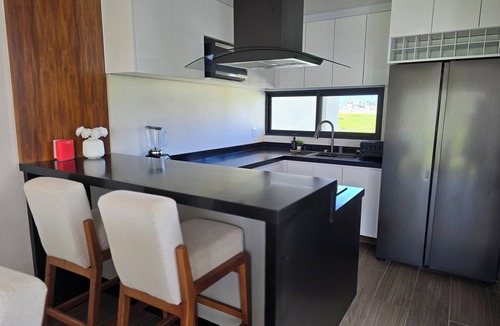 Ixmiquilpan House | Casa Olivo with double height living room, surrounded by a large garden.