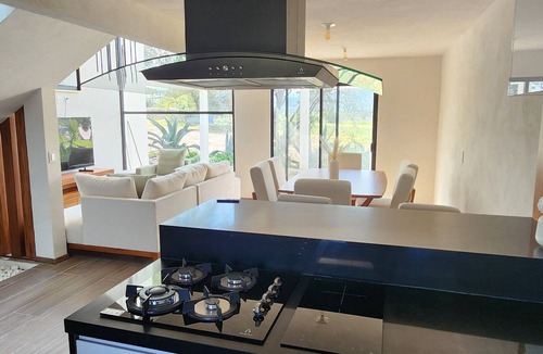 Ixmiquilpan House | Casa Olivo with double height living room, surrounded by a large garden.