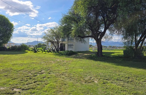Ixmiquilpan House | Casa Olivo with double height living room, surrounded by a large garden.