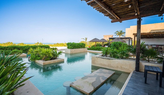 Contemporary beachfront apartment with pool, gym, ocean views, and balcony space